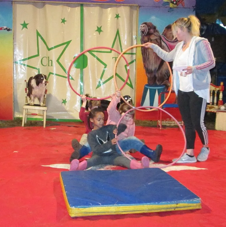 Hund springt &uuml;ber Kinder durch den Reifen